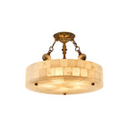 Clérachic alabaster ceiling light with a wider drum and brass canopy, shown lit and cut out on a plain white backdrop.