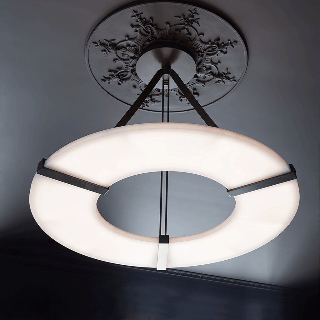 The Clérachic halo pendant seen from below, its lit ring against a charcoal ceiling.