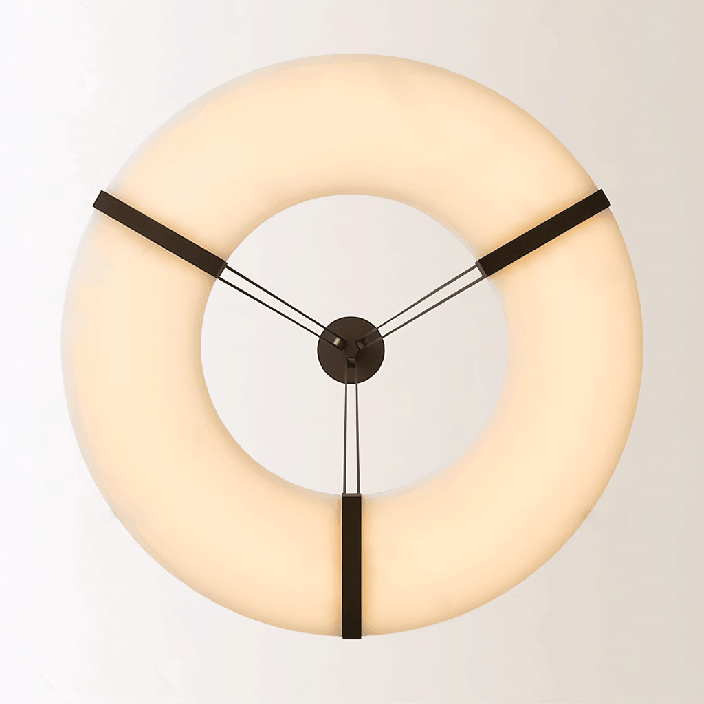 The Clérachic halo pendant viewed head-on, three bronze straps meeting at the centre.