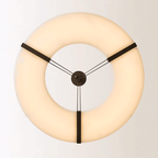The Clérachic halo pendant viewed head-on, three bronze straps meeting at the centre.