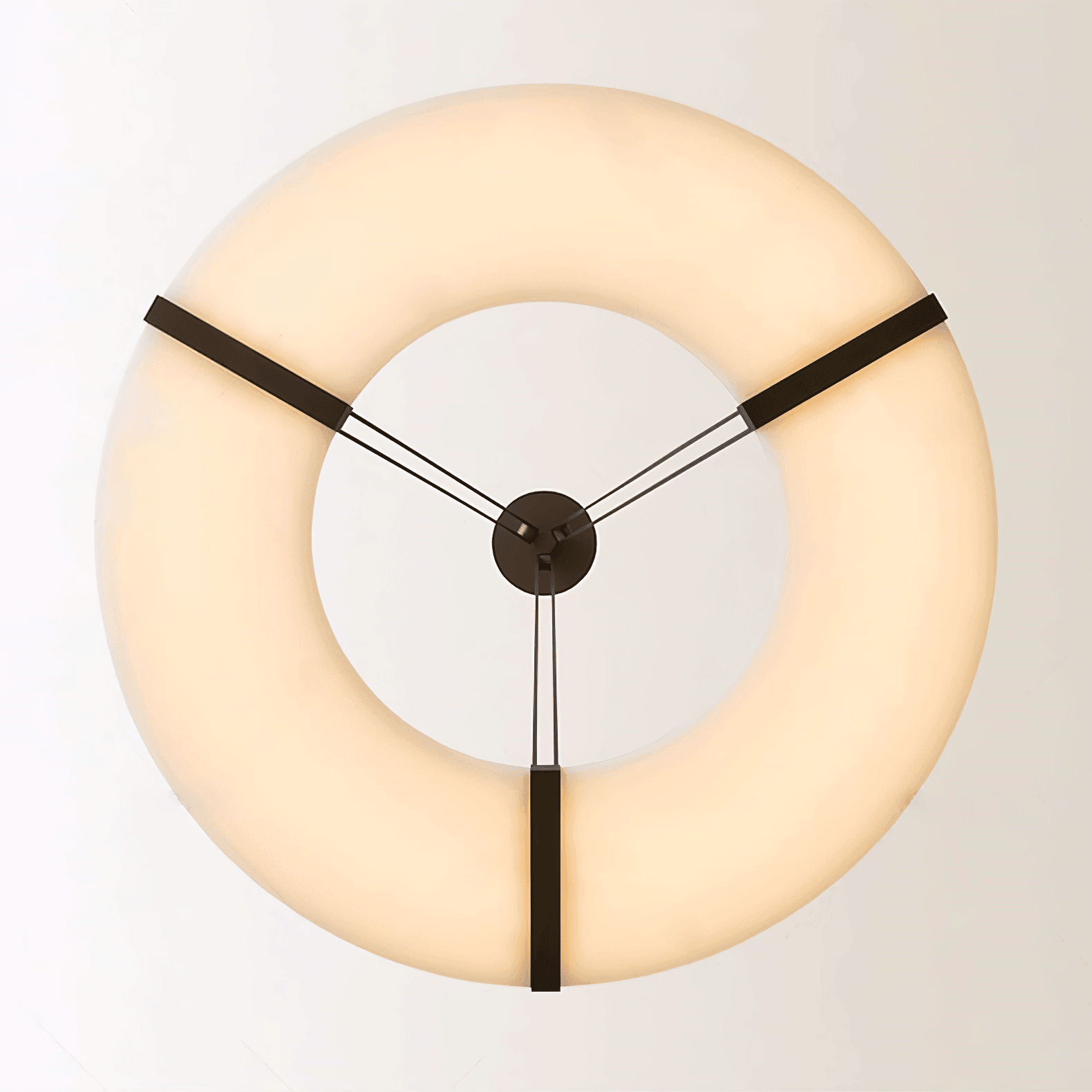 The Clérachic halo pendant viewed head-on, three bronze straps meeting at the centre.