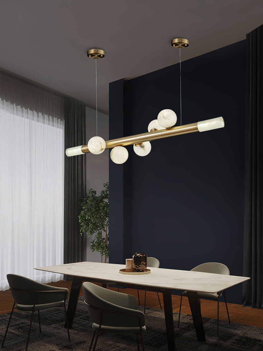 Clérachic Alabaster Linear Bar Pendant Light running the length of a marble dining table in a dark blue room by tall curtains.