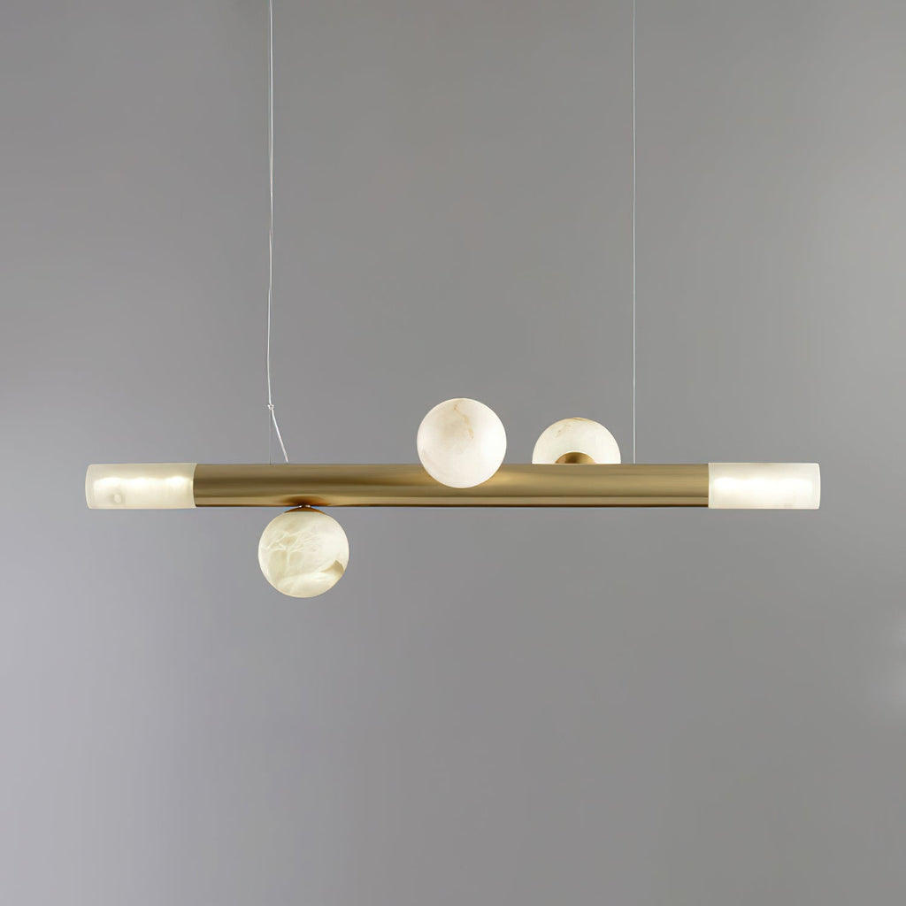 Three-globe Clérachic Alabaster Linear Bar Pendant Light on a soft grey backdrop, two stones above the bar and one below.