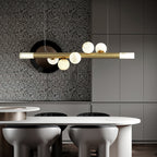 Clérachic Alabaster Linear Bar Pendant Light over a white oval kitchen table, hung against a terrazzo and grey cabinet wall.