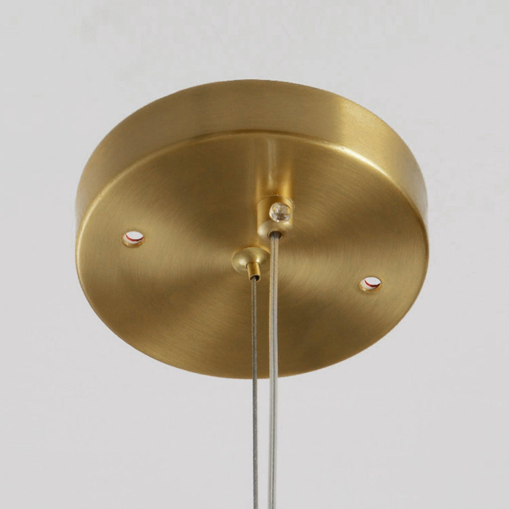 Detail of a brass ceiling canopy on the Clérachic Alabaster Linear Bar Pendant Light, with the two steel cables it carries.