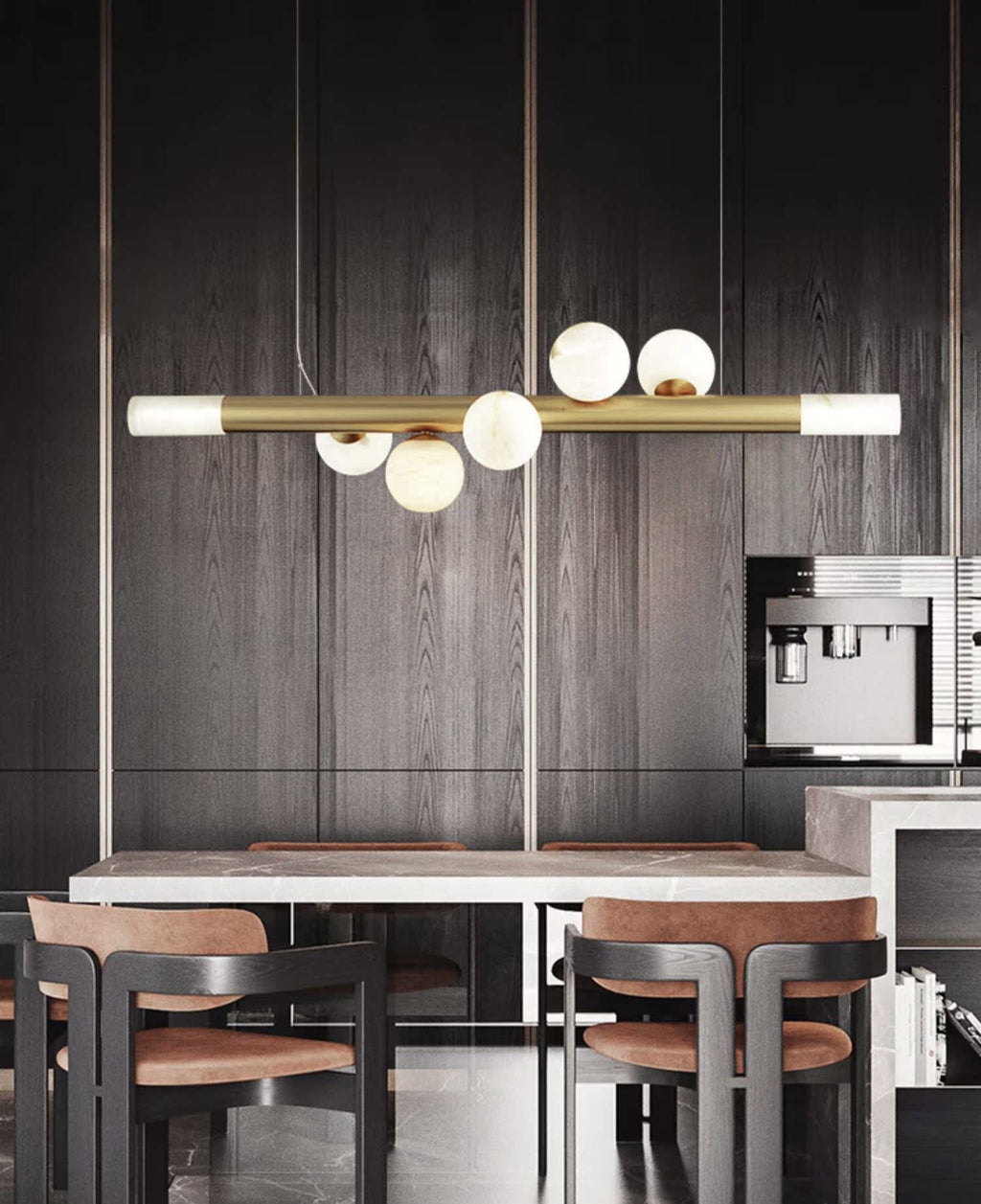 Clérachic Alabaster Linear Bar Pendant Light over a marble table in a dark oak kitchen with tan leather chairs.