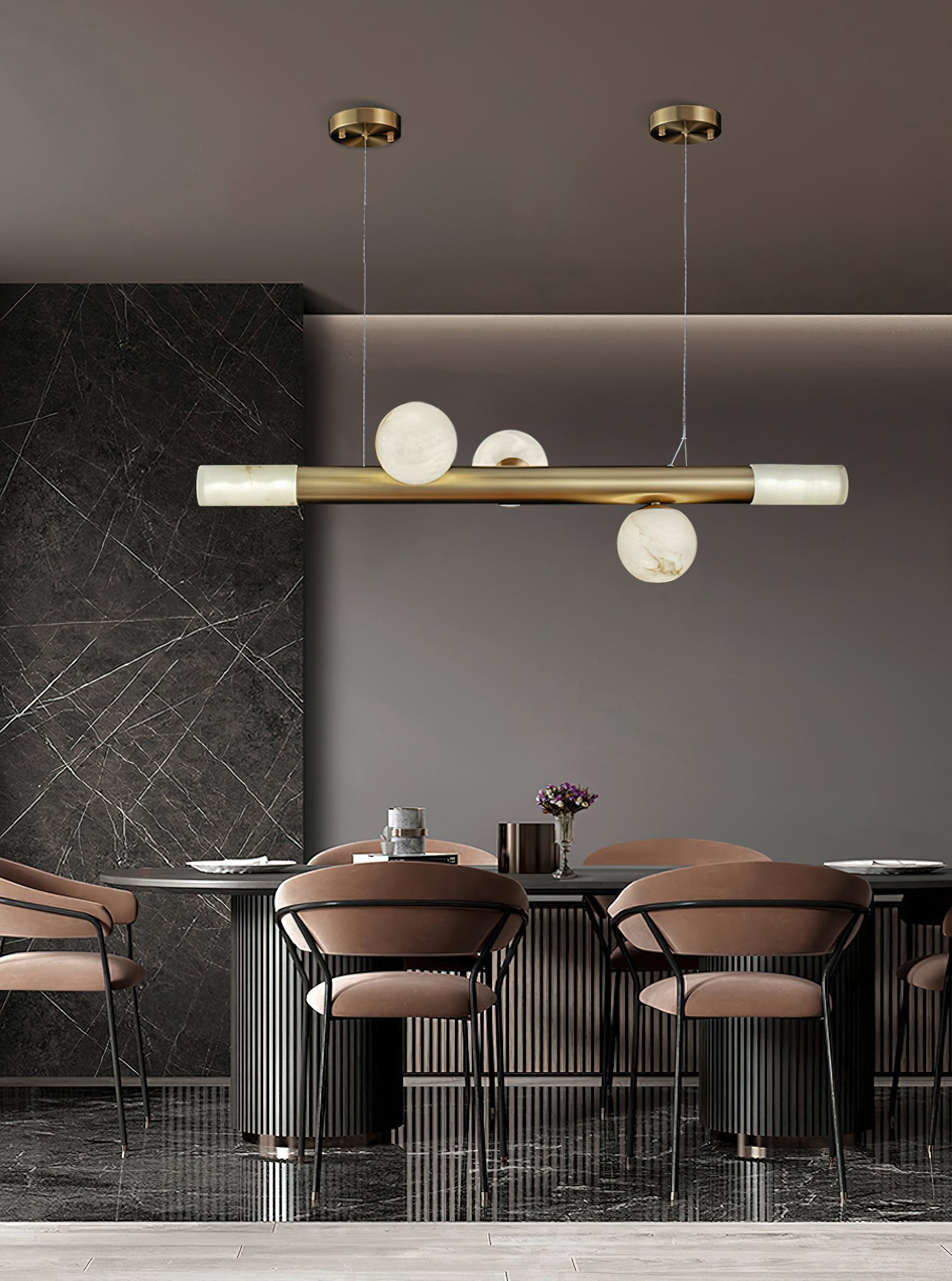 Three-globe Clérachic Alabaster Linear Bar Pendant Light above a fluted dining counter in a dark marble-clad room.