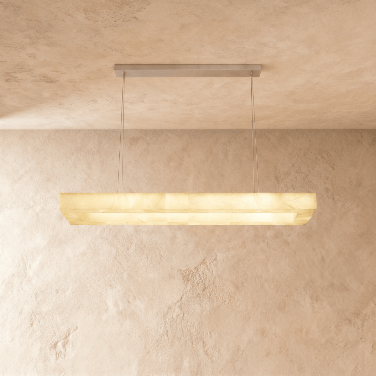 Clérachic long rectangular alabaster chandelier with a stepped stone shade, glowing evenly against plaster.