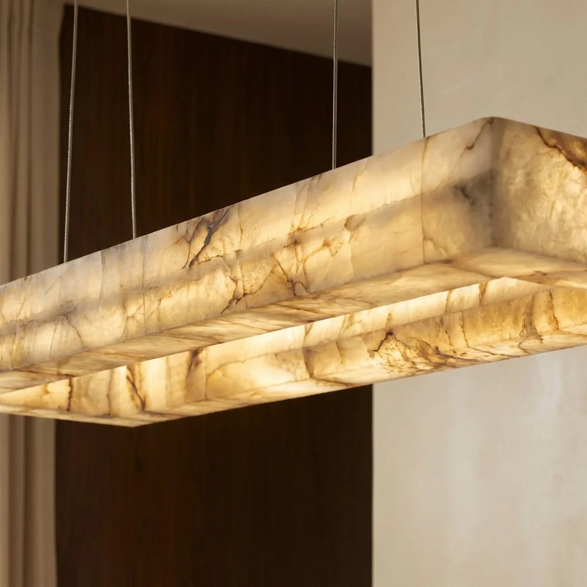 Close view of the Clérachic alabaster chandelier, warm light showing the natural veining of the stone shade.