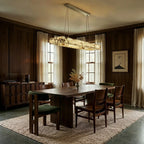 Clérachic rectangular alabaster chandelier over a walnut dining table in a panelled room with linen curtains.