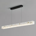 The Clérachic pendant photographed square to the camera, showing the full run of alabaster and the slim black mounting bar above.