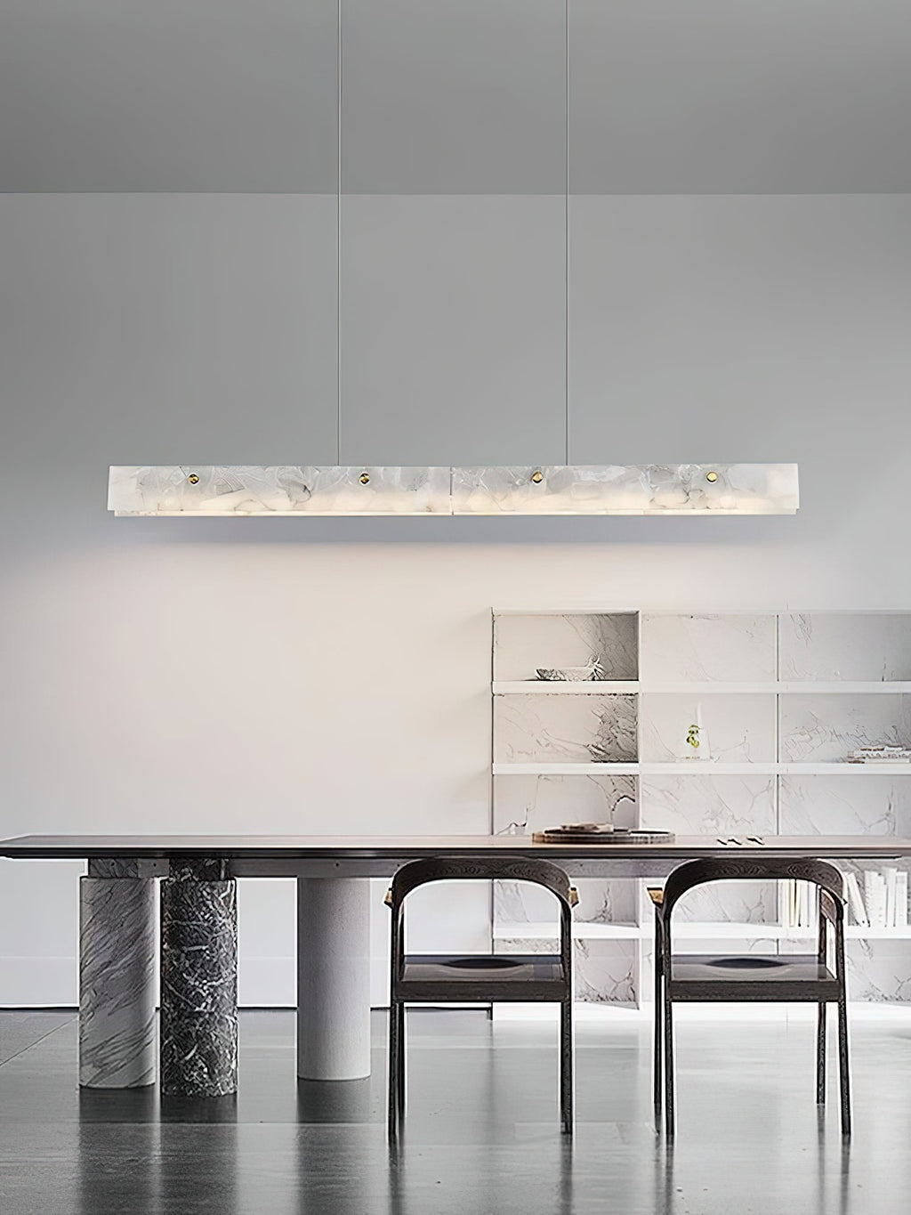 The Clérachic bar glowing above a marble-base dining table, with open shelving along the wall behind.