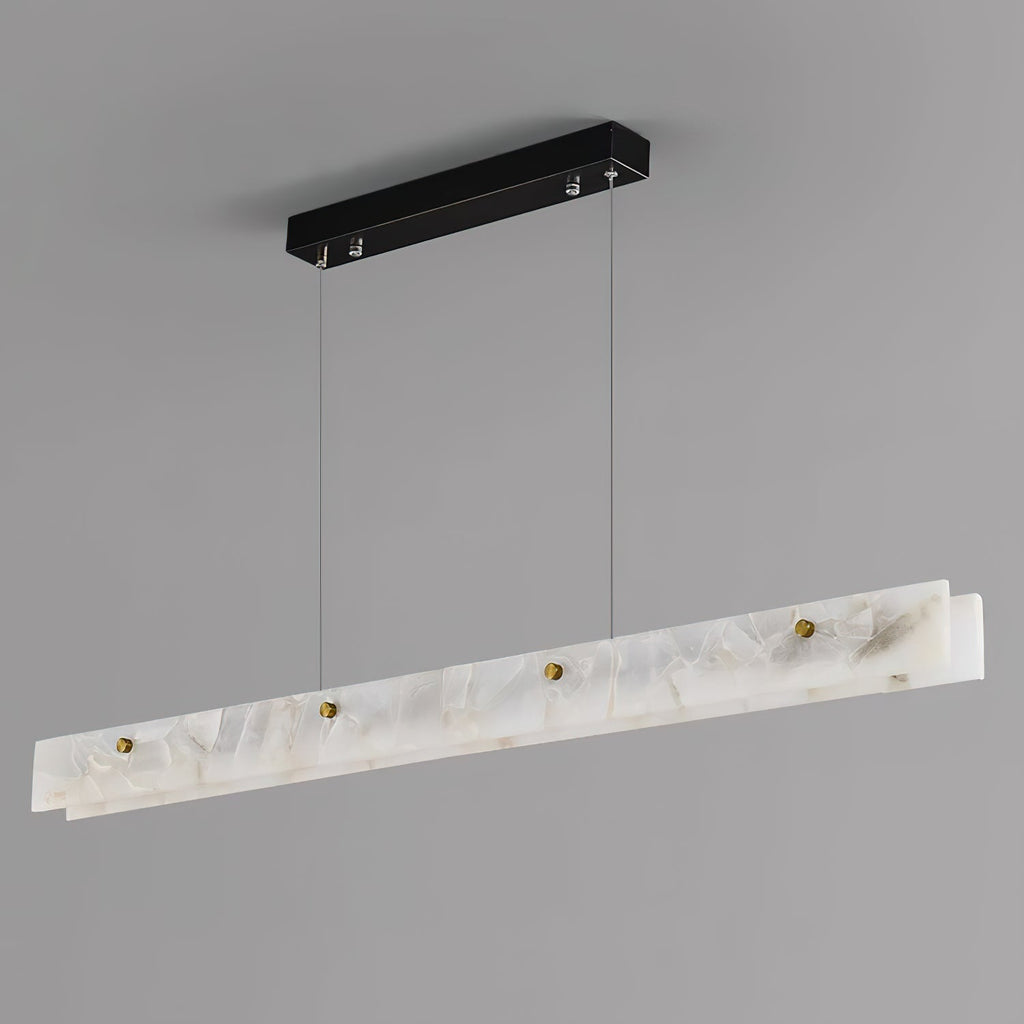 The Clérachic pendant from below and to one side, showing the black canopy, steel cables and brass thumb studs unlit.