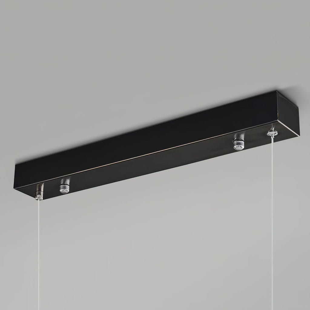 The Clérachic canopy in close-up, a slim matte black bar with the two suspension cables leaving its underside.
