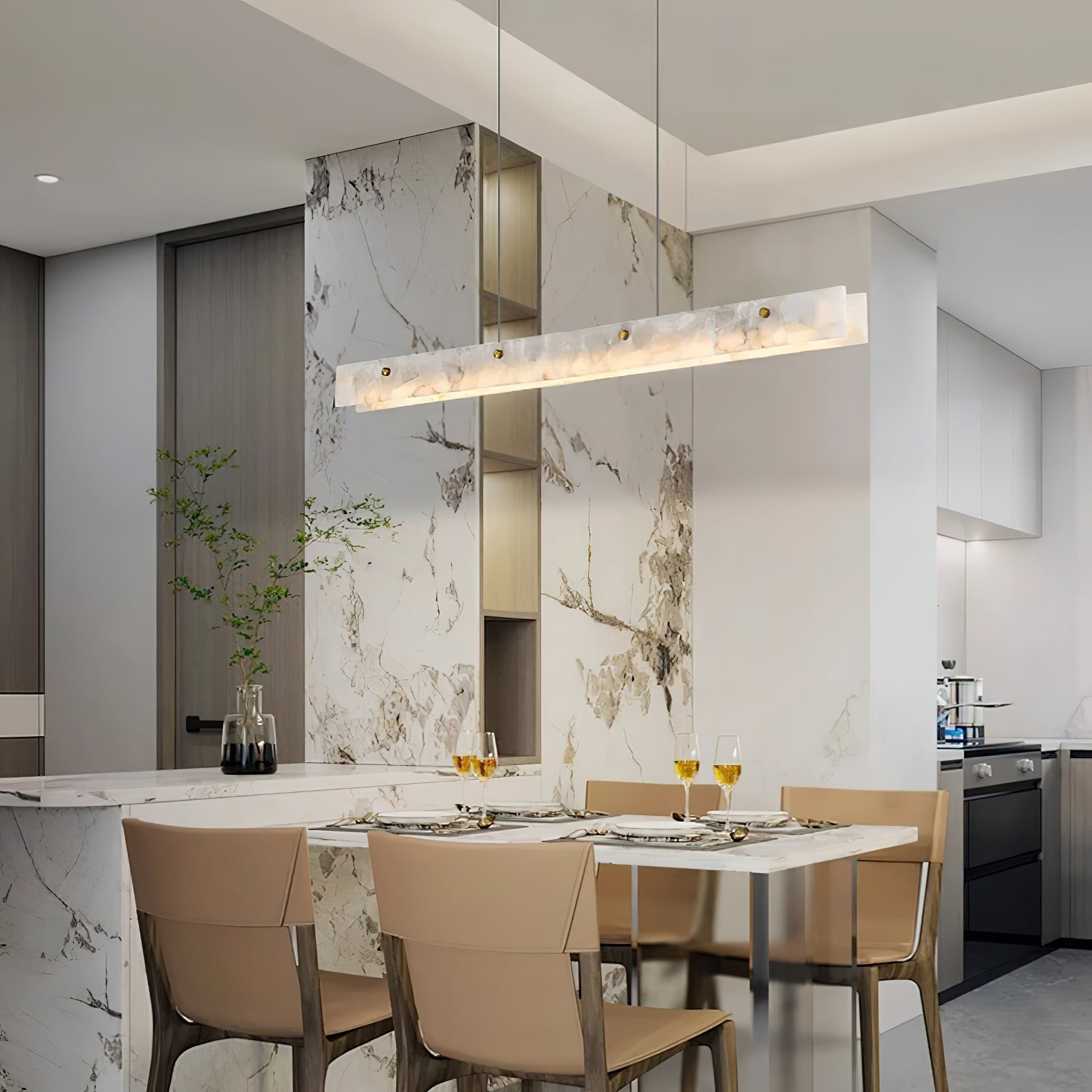 The Clérachic bar above a laid dining table, warm light against a bold marble feature wall and open kitchen beyond.