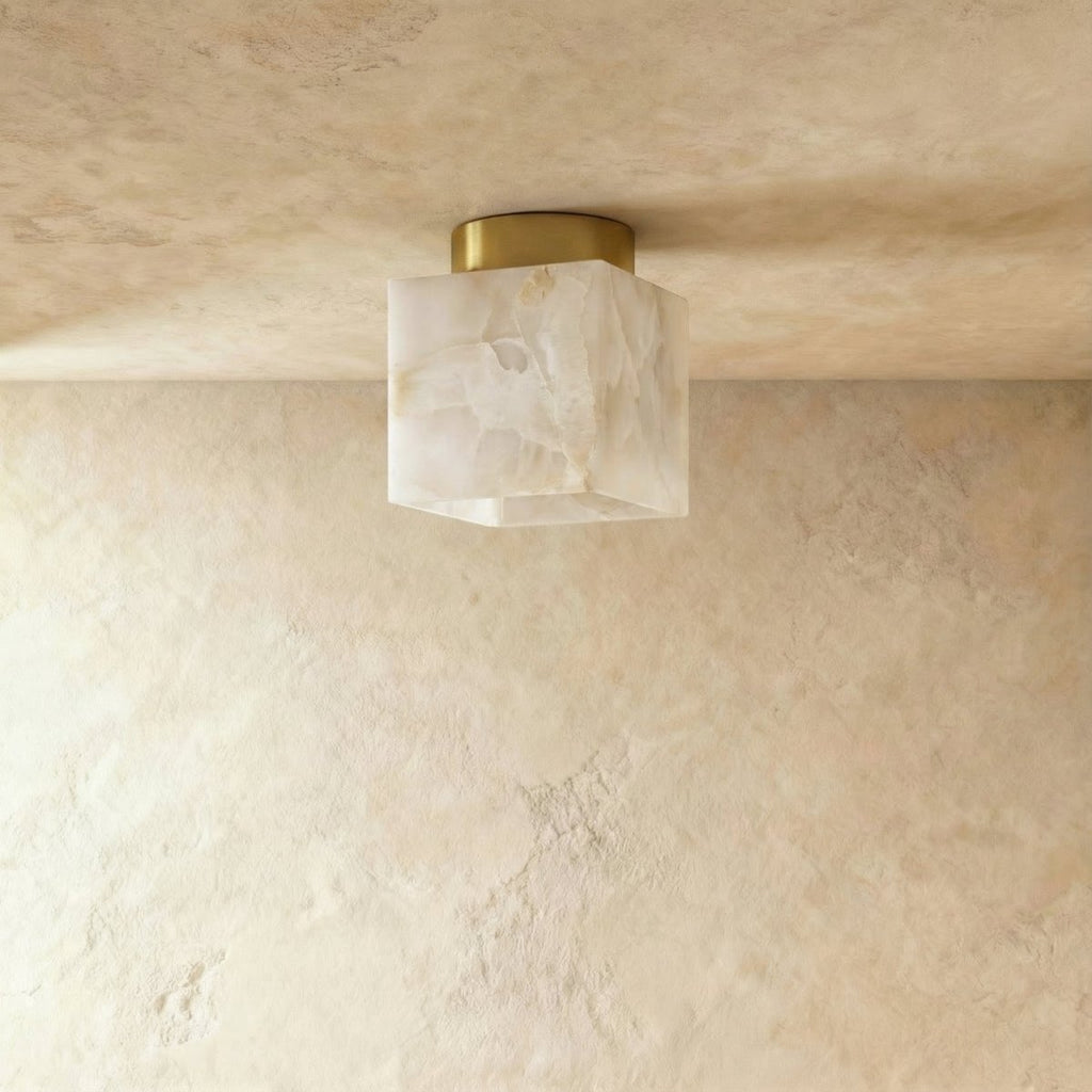 Clérachic square veined alabaster ceiling light unlit, cream and grey veining on a round brass canopy, flush to plaster.