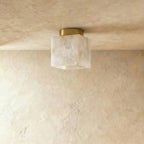 Clérachic square veined alabaster ceiling light unlit, cream and grey veining on a round brass canopy, flush to plaster.