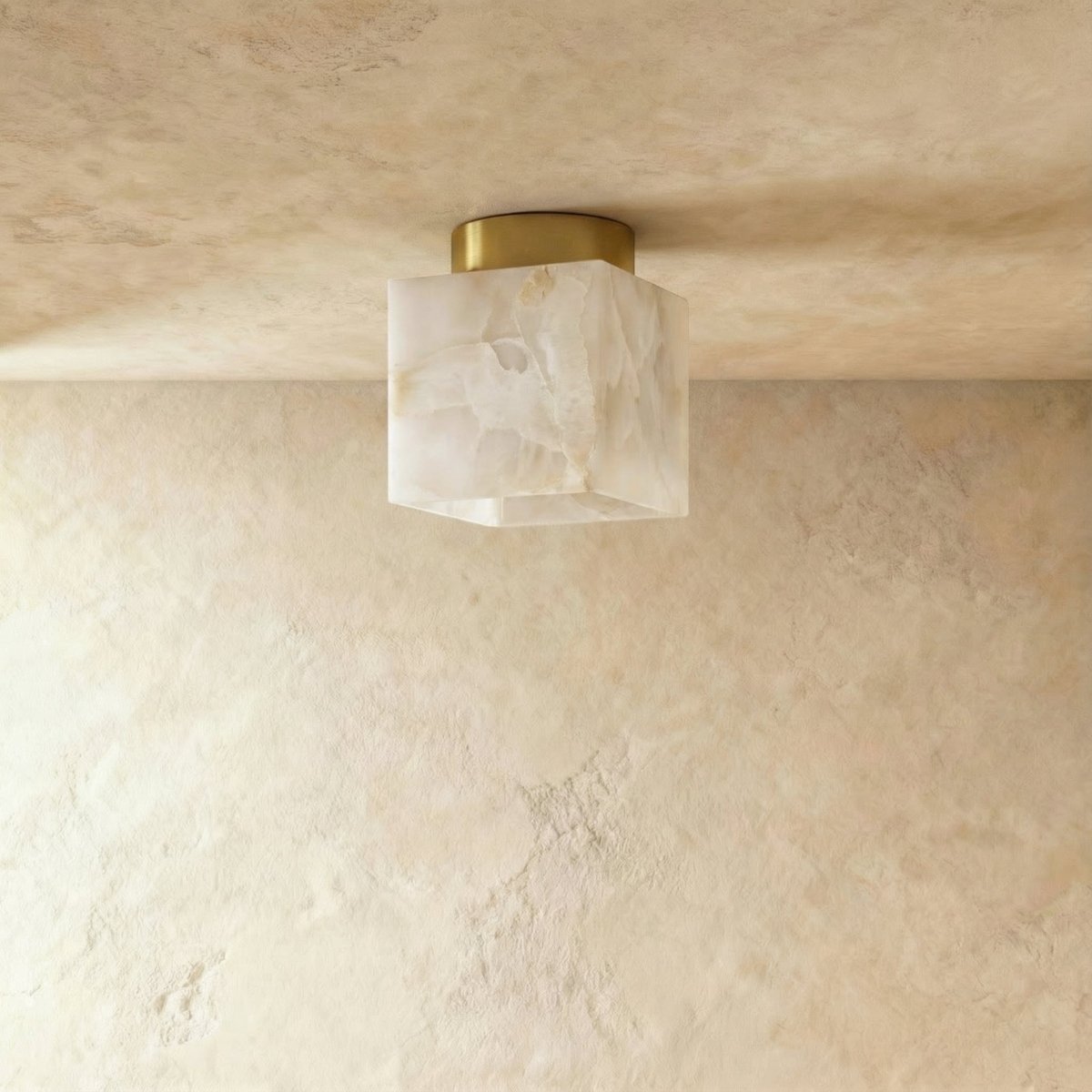 Clérachic square veined alabaster ceiling light unlit, cream and grey veining on a round brass canopy, flush to plaster.