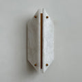 Unlit Clérachic alabaster wall sconce reading as sculpture, a pale faceted shield standing just off a plaster wall.