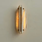 Clérachic jade wall sconce lit head on, both honey-veined panels glowing warm around a central brass bar.