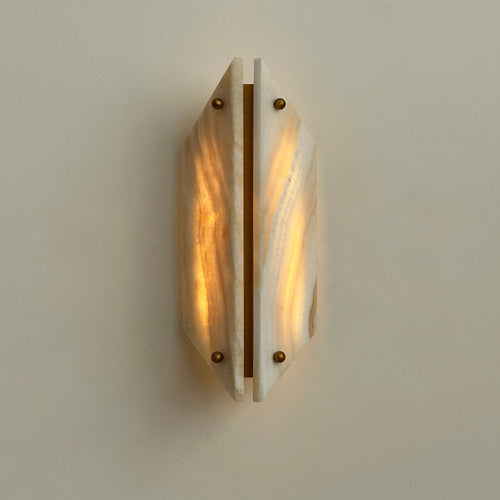 Clérachic jade wall sconce lit head on, both honey-veined panels glowing warm around a central brass bar.