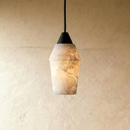 Clérachic alabaster pendant with a dark conical cap on a black cord, glowing warm against a pale limewash wall.