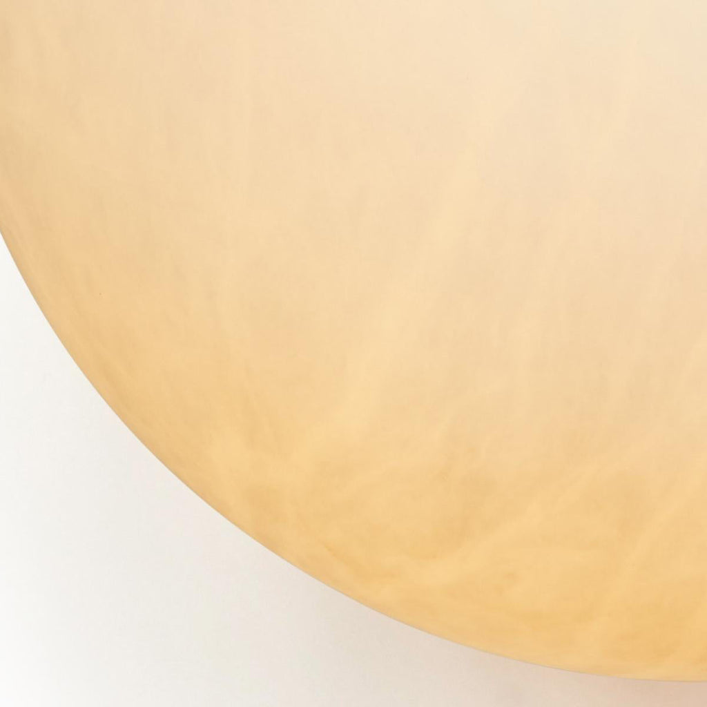 The Clérachic globe in macro, alabaster translucency showing cloudy honey veining across the stone.