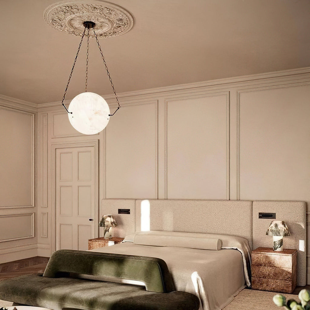 Clérachic alabaster pendant hung from a plaster ceiling rose above a bed, glowing softly in a panelled bedroom.