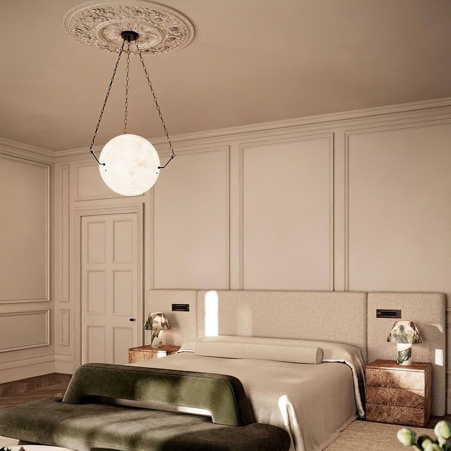 Clérachic alabaster pendant hung from a plaster ceiling rose above a bed, glowing softly in a panelled bedroom.
