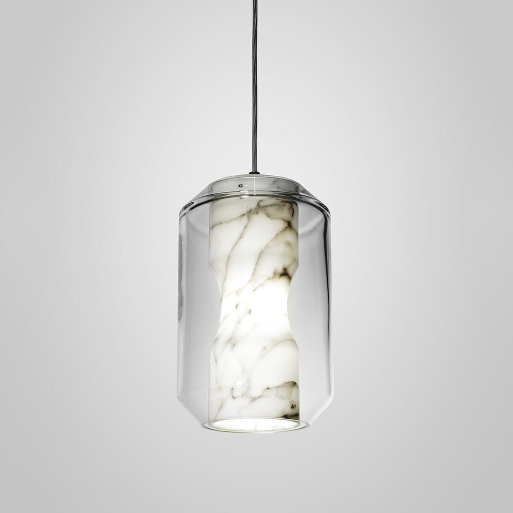 Lit tall cylinder from the Clérachic Alabaster Pendant Light range, its open base casting a bright ring of light below the veined stone column.