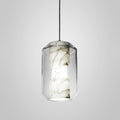 Lit tall cylinder from the Clérachic Alabaster Pendant Light range, its open base casting a bright ring of light below the veined stone column.