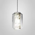 Lit tall cylinder from the Clérachic Alabaster Pendant Light range, its open base casting a bright ring of light below the veined stone column.