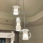 Seen from below, three Clérachic Alabaster Pendant Lights show the open base that drops working light onto the room.