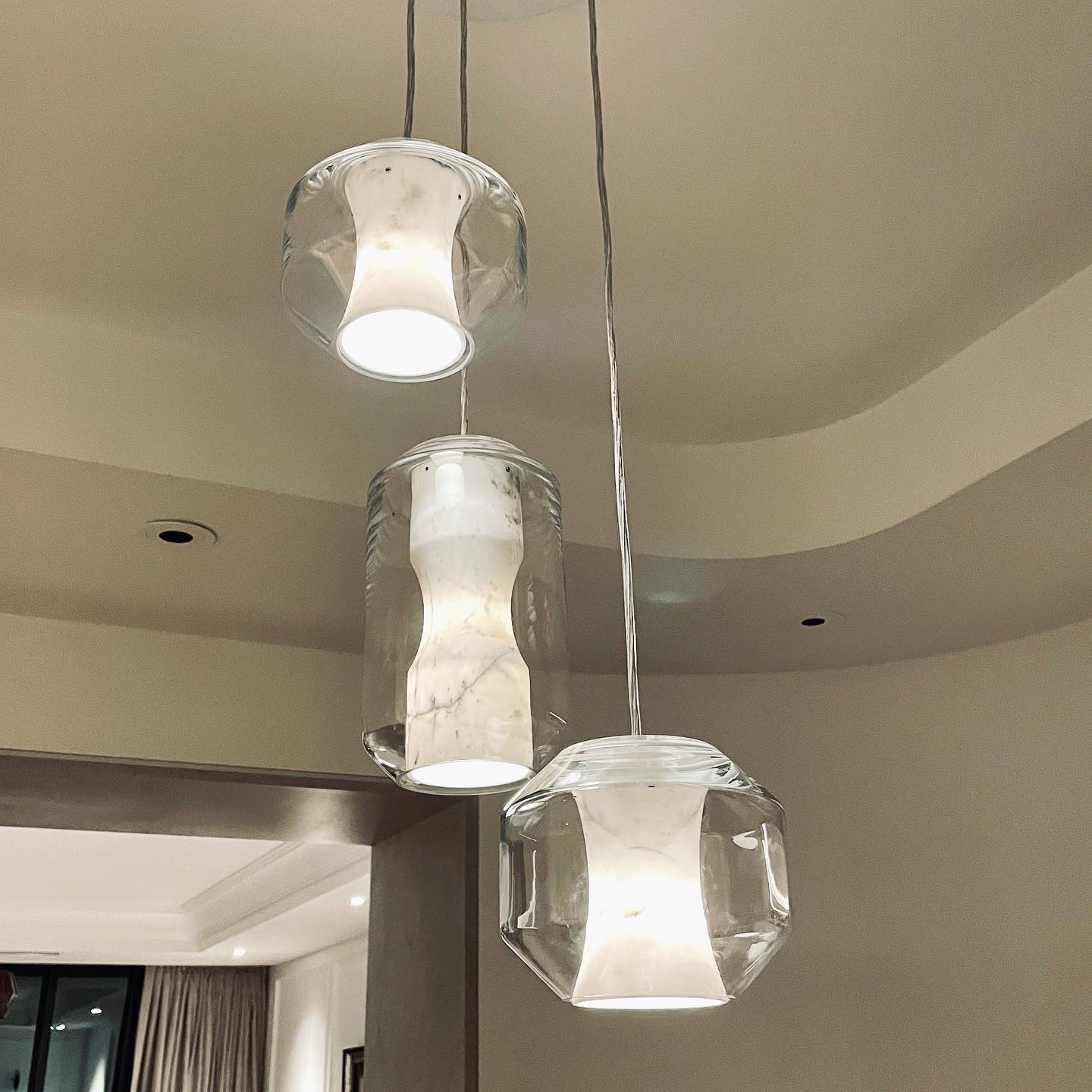 Seen from below, three Clérachic Alabaster Pendant Lights show the open base that drops working light onto the room.