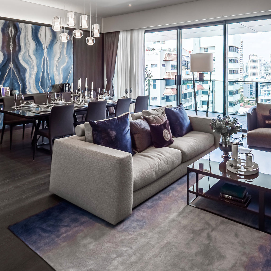 Open-plan view of Clérachic Alabaster Pendant Lights over the dining table, seen across the sofa in a modern apartment.