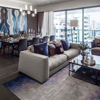 Open-plan view of Clérachic Alabaster Pendant Lights over the dining table, seen across the sofa in a modern apartment.