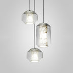 Both sizes together: two barrels and one tall cylinder of the Clérachic Alabaster Pendant Light lit in a staggered studio group.