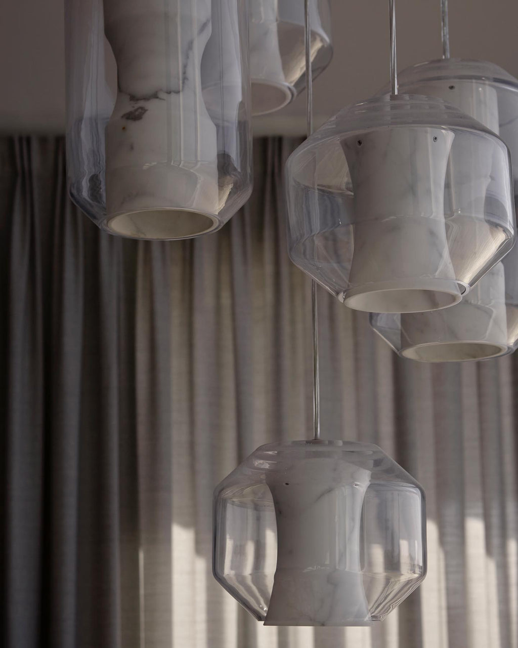 Daylit close-up of a Clérachic Alabaster Pendant Light cluster, the open bases and faceted glass edges clearly visible.