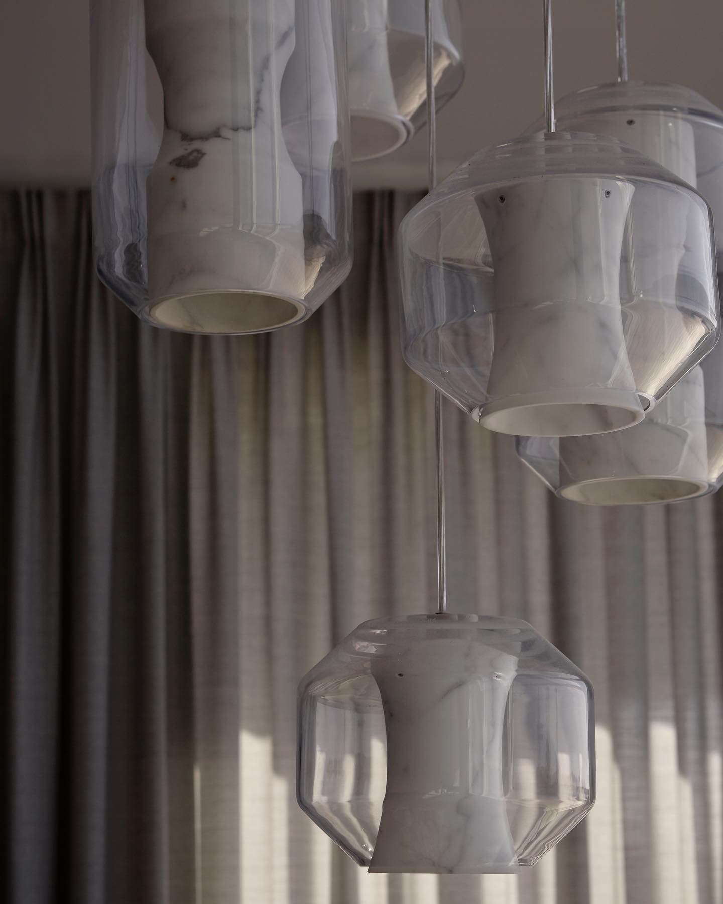 Daylit close-up of a Clérachic Alabaster Pendant Light cluster, the open bases and faceted glass edges clearly visible.