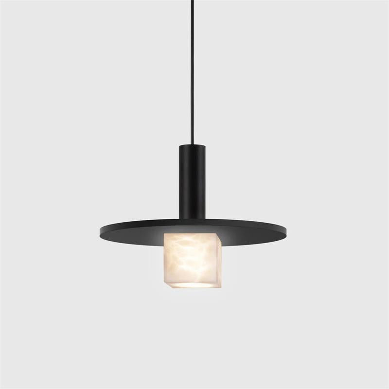 Clérachic Alabaster Pendant Light in the large size, matte black disc catching light above the softly glowing stone block.