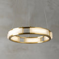A Clérachic Alabaster Ring Chandelier at the smaller span, veining showing through panels lit from within on fine clear cables.
