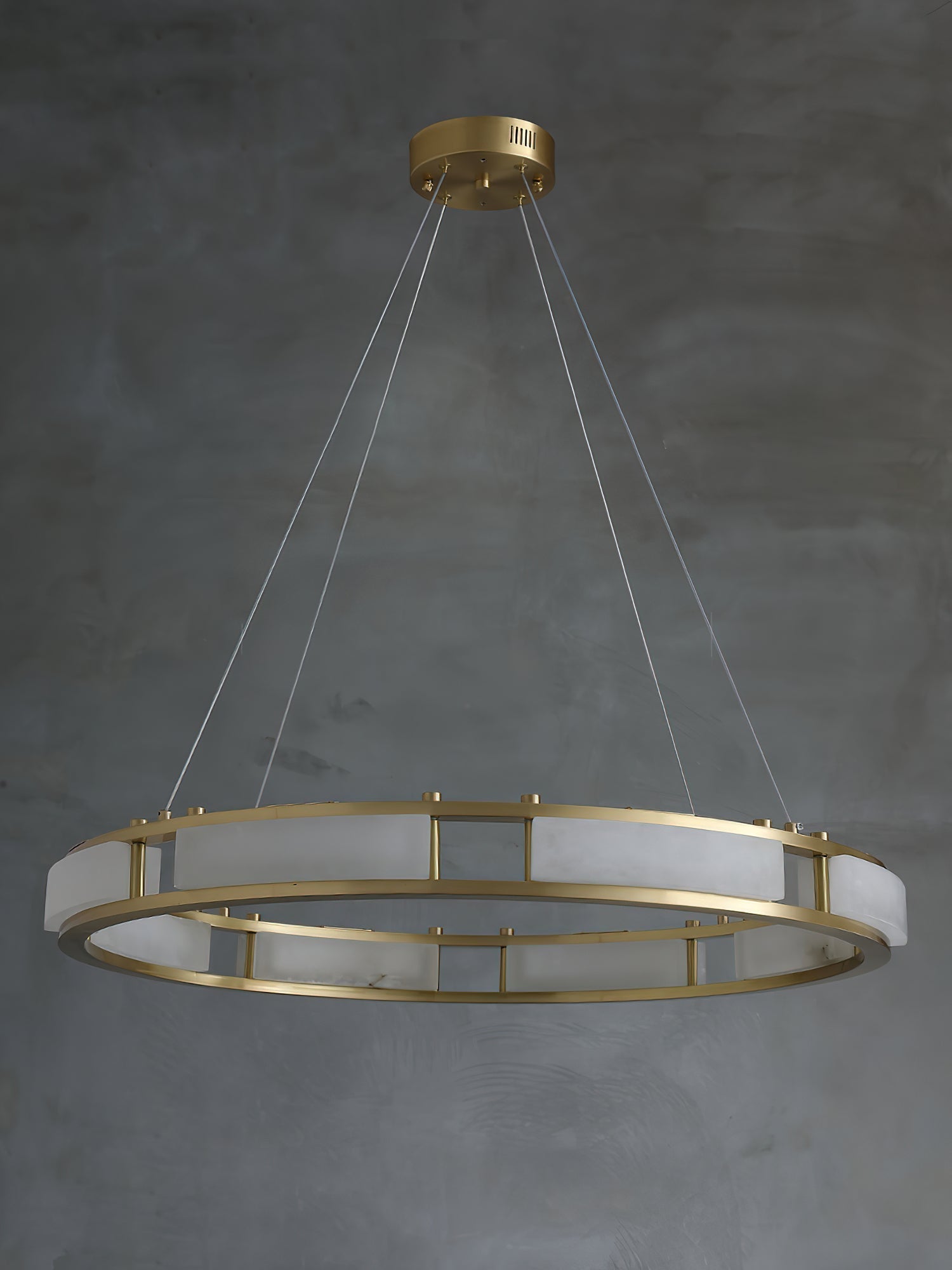 Clérachic Alabaster Ring Chandelier shown unlit at full drop, four clear cables running up to a brass ceiling canopy.