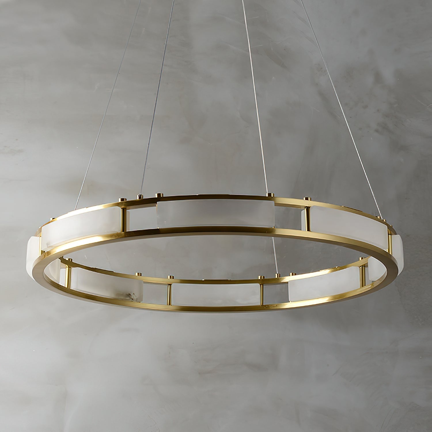 Unlit Clérachic Alabaster Ring Chandelier viewed from above, brass posts spacing the pale alabaster panels around the ring.