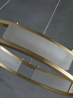 Close view of a Clérachic Alabaster Ring Chandelier panel, quarried stone curved to the ring and held by brushed brass rails.