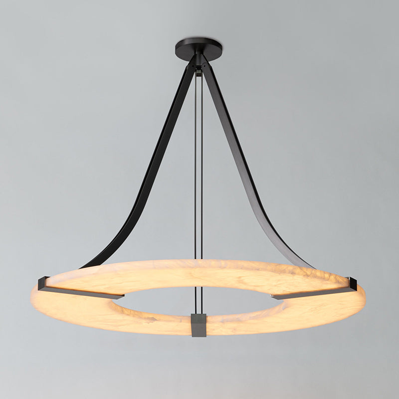 Eye-level view of the Clérachic Alabaster Ring Chandelier, the curved bronze arms sweeping from canopy down to the pale stone ring.
