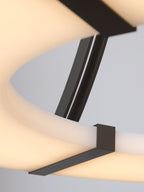 Macro of the Clérachic Alabaster Ring Chandelier, a squared bronze strap crossing the softly lit inner edge of the ring.