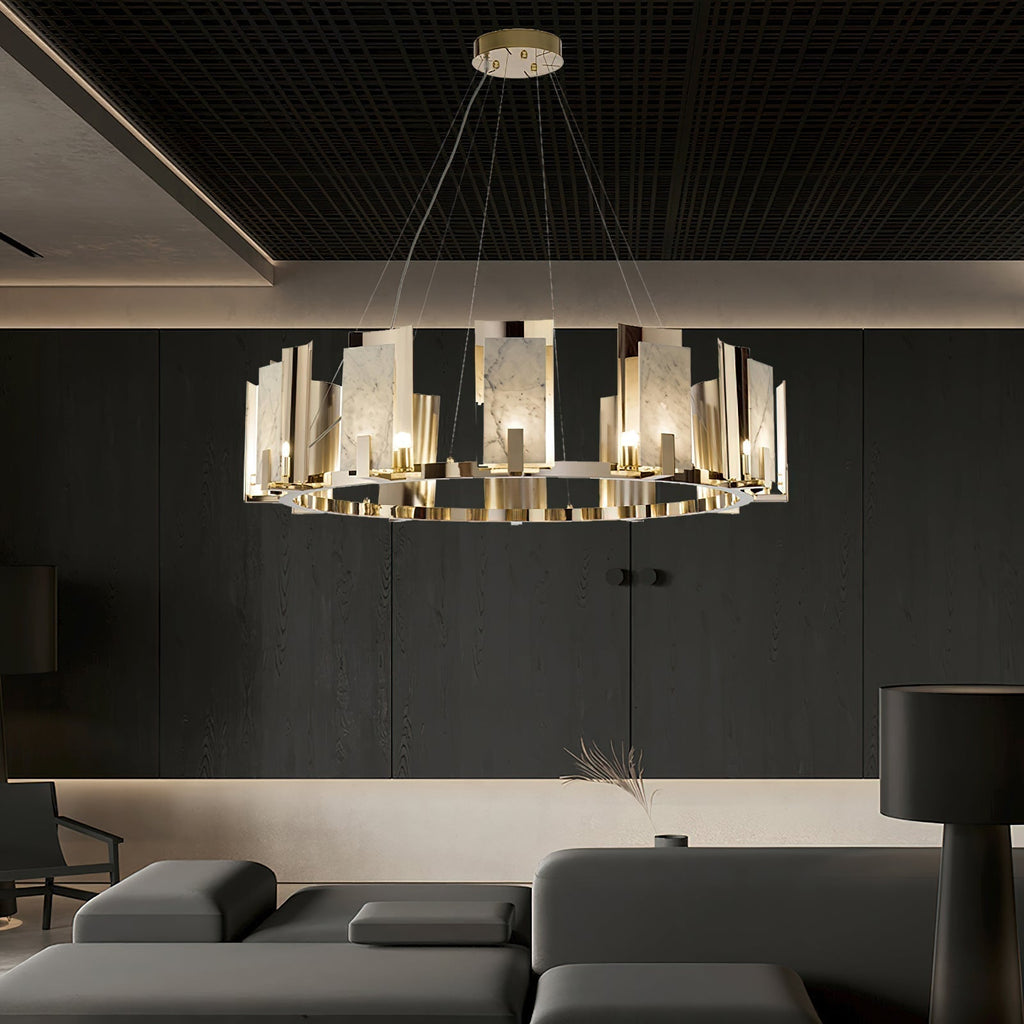 Clérachic Alabaster Ring Chandelier lit above a grey modular sofa in a dark-panelled living room with a black grid ceiling.