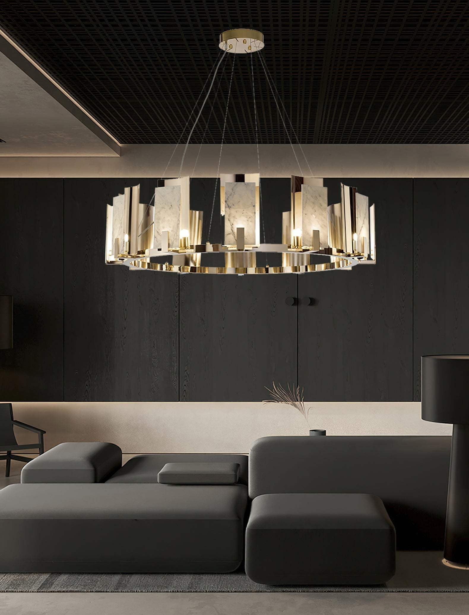 Tall view of the Clérachic Alabaster Ring Chandelier lit over charcoal seating, the stone reading bright against black joinery.