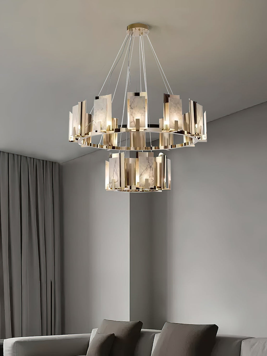 Two-tier Clérachic Alabaster Ring Chandelier lit in a soft grey room, the lower ring hanging clear beneath the upper one.
