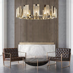 Clérachic Alabaster Ring Chandelier over two buttoned leather armchairs, glowing against a fluted wood and marble wall.